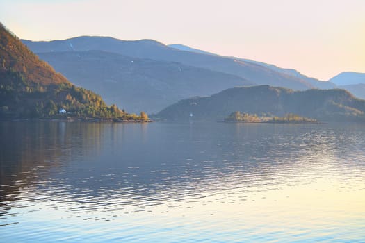 Fjord in Norway at Westcap. At dusk by the water. Mountains in the background. Landscape shot from Scandinavia