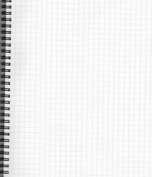 A white notebook on a spread with a checkered sheet, a close-up view from above