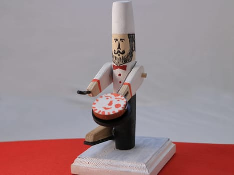 wooden toy chef with pancake in a frying pan