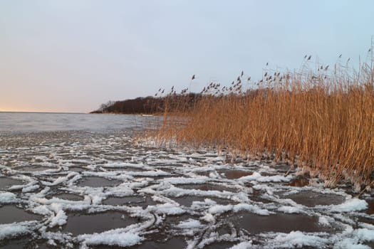 ice and white slush swaying on the surface of the lake, winter landscape