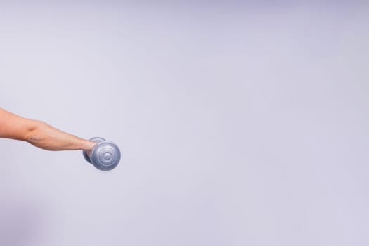 Man, dumbbell and exercise in a studio for fitness, wellness and healthy body with workout training.