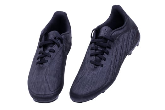 Closeup of a pair of black leather football boots isolated on white background. Professional athletics boys outdoor training shoes. Sports shoes.