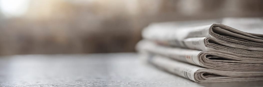 Stack of newspapers on the table in the morning light. Selective focus. Media news concept. AI generated