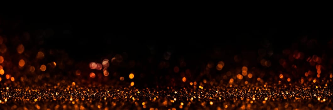 Abstract blur golden glitter on black background. Card for new year, christmas and wedding celebration. Party bokeh sparkle confetti textured layout. Classy elegant design.