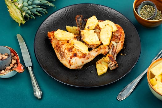 Spicy chicken legs fried with pineapple pieces. Baked chicken meat.