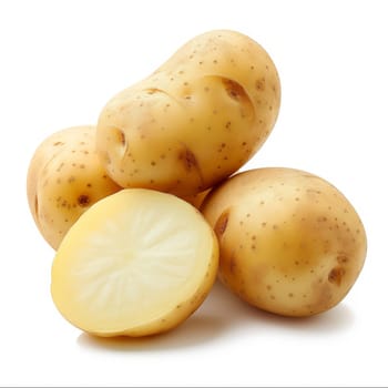 Close-up of fresh, whole and sliced yellow potatoes on a white background
