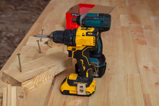 Two carpenter's tools on a new wooden plank floor.