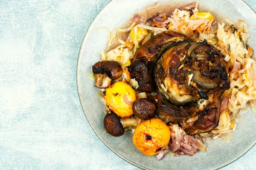 Pork knee roasted in cabbage. Czech traditional food. Top view. Space for text.