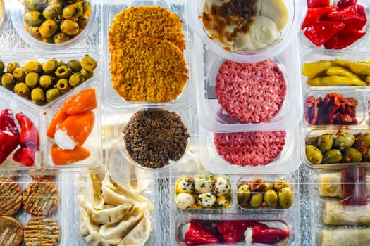 A display of variety of prepackaged food products in plastic boxes.