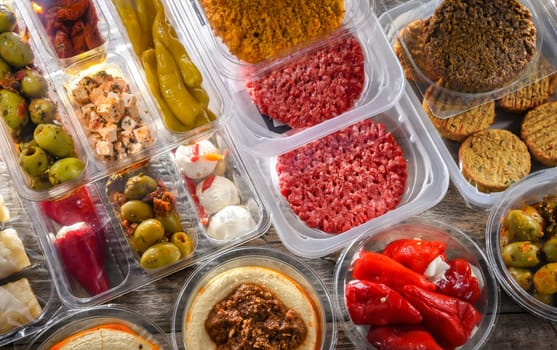 A display of variety of prepackaged food products in plastic boxes.