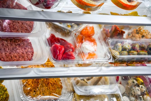 A display of variety of prepackaged food products in plastic boxes.