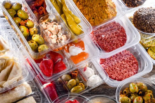 A display of variety of prepackaged food products in plastic boxes.