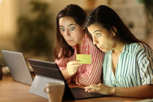 Perplexed tele workers buying online working in the night at home
