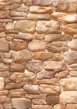 Decorative convex overlay made of stone in the form of brown cobblestones .Texture or background.