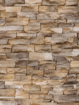 Decorative stone in the form of sharp uneven brown tiles in close-up.Texture or background.