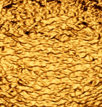 Heavily crumpled gold-colored metal sheet.Texture or background.