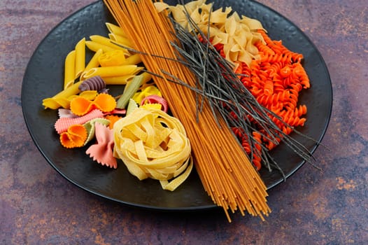 Different types and shapes of pasta, noodles and spaghetti. Top view with copy space