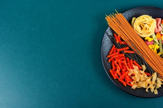 Different types and shapes of pasta, noodles and spaghetti. Top view with copy space
