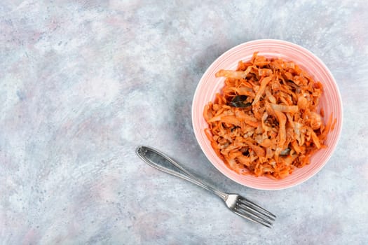Tasty stewed cabbage in a ceramic bowl. Fried Sauerkraut. German cuisine.
