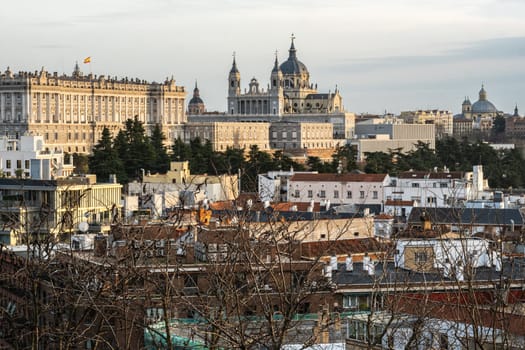 Panoramic winter view of the city of Madrid from the Parque del Oeste hill. From left to right: the Royal Palace, the Catedral de Santa Maria la Real de Almudena and the dome of the Basilica of St Francis the Great