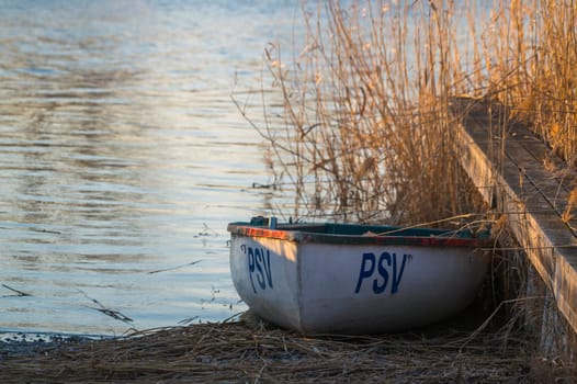 small boat on the shore of lake neusiedlersee