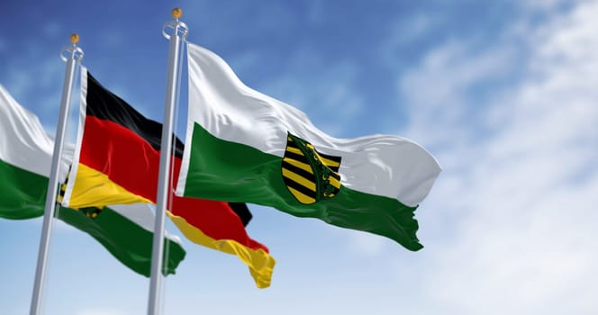 The flag of Saxony waving in the wind on a clear day. Saxony is a landlocked state of Germany
