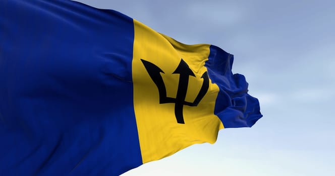 Close-up of Barbados national flag waving in the wind on a clear day. Blue and yellow flag with a black Triton in the center. 3d illustration render. Rippled Fabric. Selective focus.