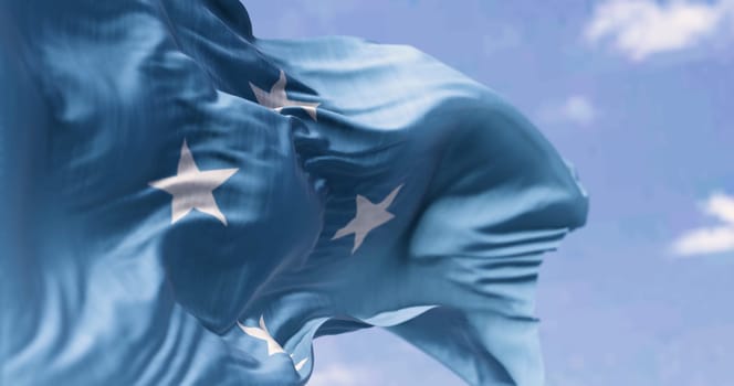 National flag of Federated states of Micronesia waving in the wind on a clear day. Independent state located in the Pacific Ocean. 3d illustration render. Selective focus