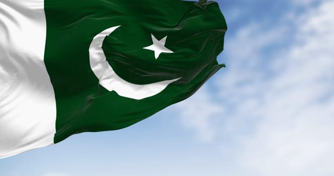 Pakistan National flag waving on a clear day. Green with white band on hoist  white crescent moon and five-pointed star. 3d illustration render