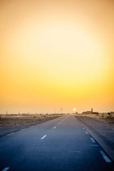 Driving through a village in the desert in Mauritania at sunset