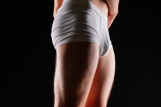 Male muscular legs body-building, muscle man in a white sport panties