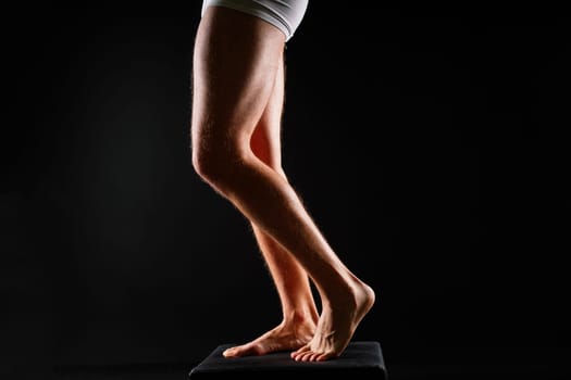 Male muscular legs body-building, muscle man in a white sport panties
