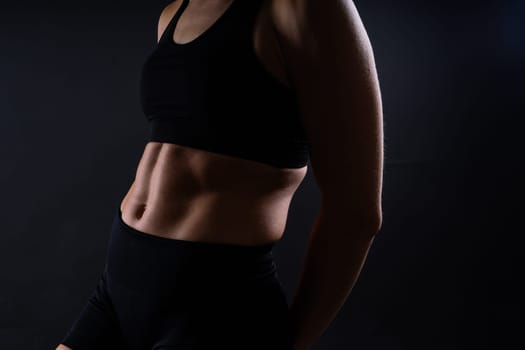 Close up of woman back with muscles after workout. Female bodybuilder with perfect biceps