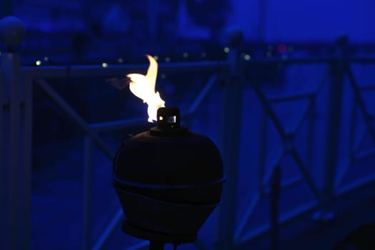 Burning oil lamp by the water in a relaxed atmosphere in Denmark. Still life
