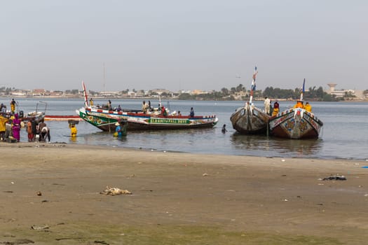 Dakar, Senegal. August 18, 2019: Fishermen with a fishing boat in a beach at Dakar, one of the many fishing beaches of Dakar, Senegal, West Africa