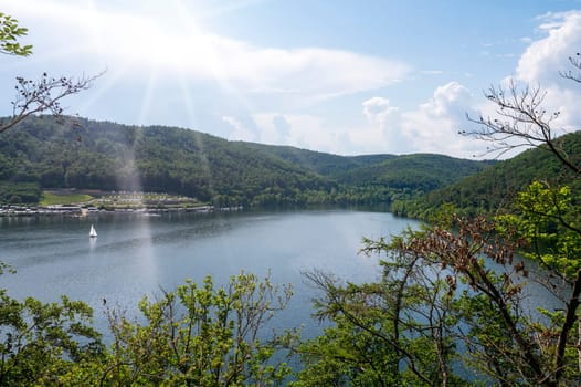 View of the Lake Eder with sky,sunrays, sailing ship and clouds, Hesse, Germany