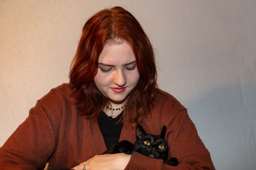 A girl with her black cat and white background