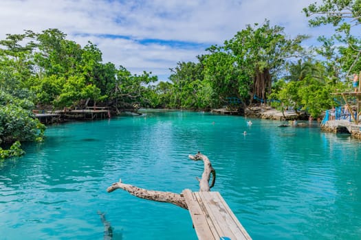 Port Vila, Vanuatu: 01 June 2023: People swimming in Blue Lagoon, a popular scenic turquoise swimming hole near Port Vila, Efate Island, Vanuatu, Melanesia