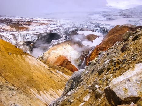 Geysers near the volcano. The nature of Kamchatka, a burnt volcano, an area near a volcano