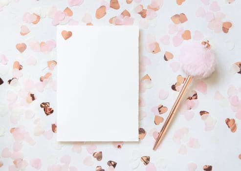 Horizontal card and envelope between pink hearts and fur pen on white table top view. Romantic mockup for Wedding, Valentines, Spring or Mothers day
