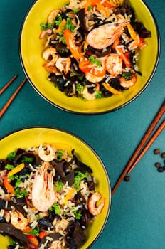 Shrimp fried rice serves on the dish. Healthy Asian meal.