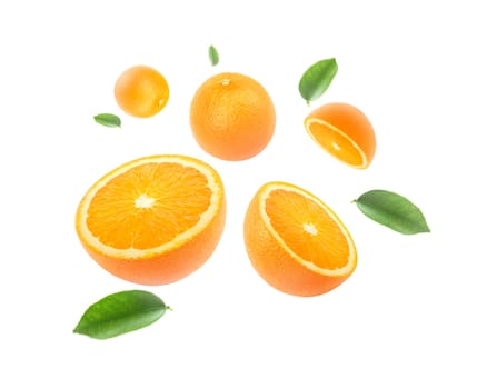 Orange with cut in half and leaves levitate isolated on white background.