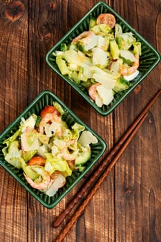 Salad with shrimp,prawns avocado and tomato in a bowl. Healthy food concept. Top view, overhead.
