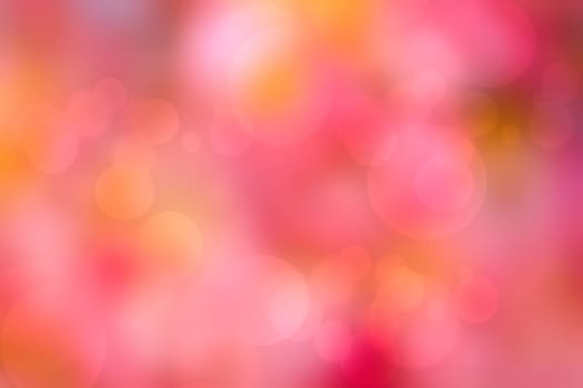 A festive abstract delicate golden yellow red orange gradient background texture with defocused bokeh circles. Card concept for Happy New Year, party invitation, valentine or other holidays.