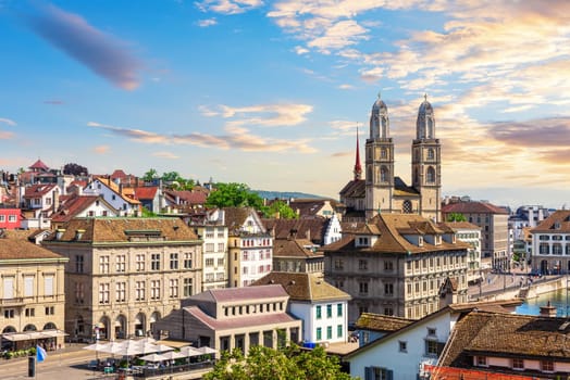 Sunset view on the downtown of Zurich by Grossm nster Romanesque Protestant church, Switzerland.