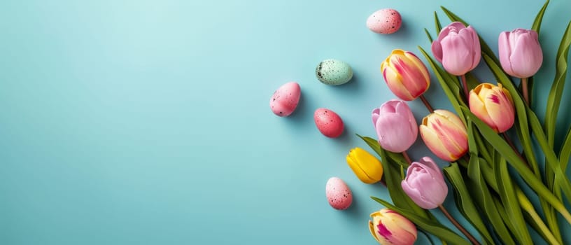 Delicate Easter eggs and spring daisies arranged on a light blue background with copy space