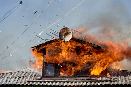 fire on the roof of a wooden house. High quality photo