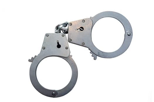 Metal handcuffs on a white isolated background, copy space. High quality photo