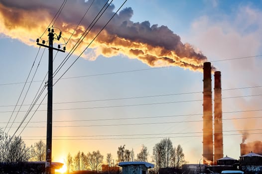 white smoke is coming out of the pipes in the blue sky. High quality photo