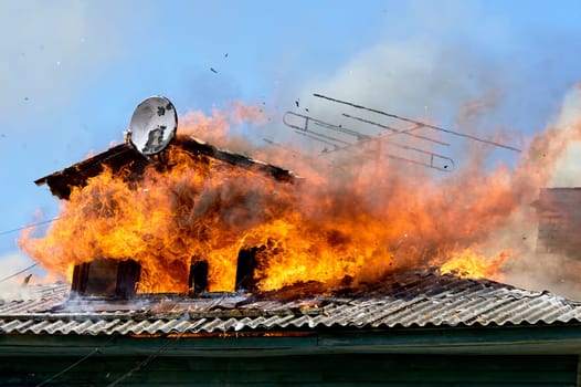 fire on the roof of a wooden house. High quality photo